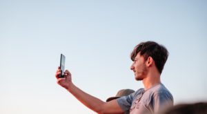 a man taking a selfie, blue sky, light, johan mouchet